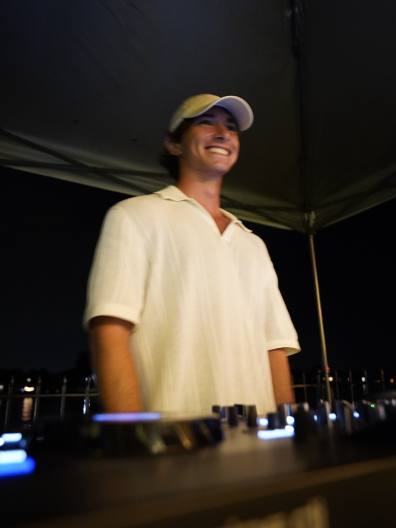 Surveillance photo: SURPHER mid-set behind the decks at a waterfront night gig